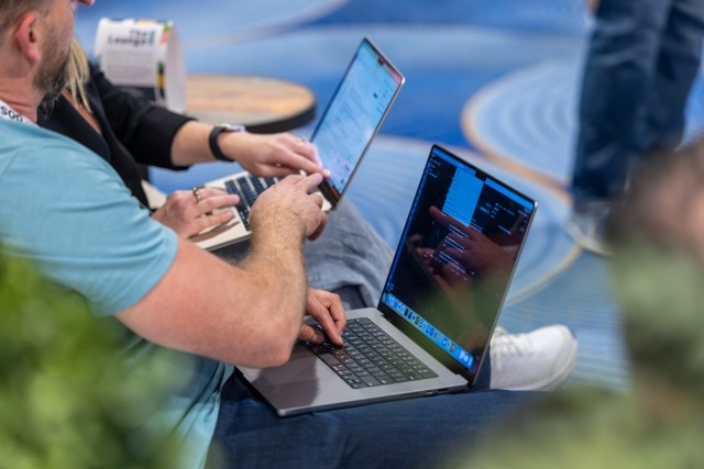 two people working at laptop