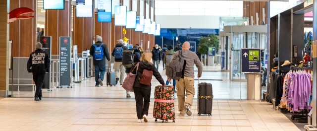 A view of the Halifax Stanfield International Airport terminal with an airplane at the gate, representing the hub of HIAA's operations.