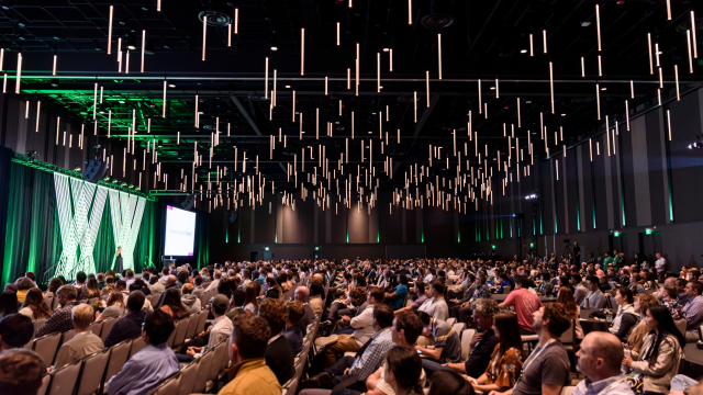 large conference audience looking at a stage