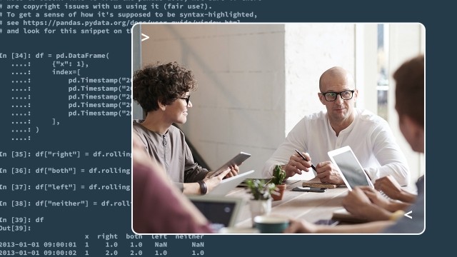A group of people talking around a desk