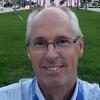 portrait of smiling Joe Gibson outside in front of large grassy area