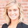 portrait of Katie Schafer in front of brick wall
