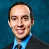 portrait of Marcos Huerta in front of dark blue textured background