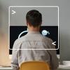 back view of a man sitting at desk working on computer with computer terminal framing him